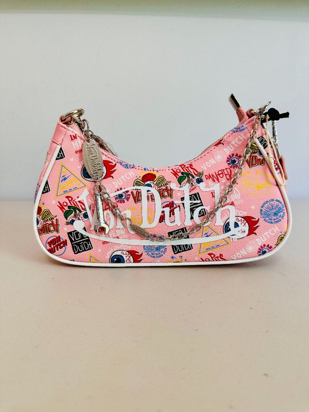 VON DUTCH FAUX LEATHER PINK JAX GRAFFITI PRINT SHOULDER BAG WITH BAG CHARM